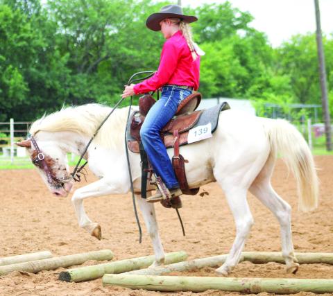 Case Capron works her horse during the 2025 Horse Show at the Saddle Club Arena.