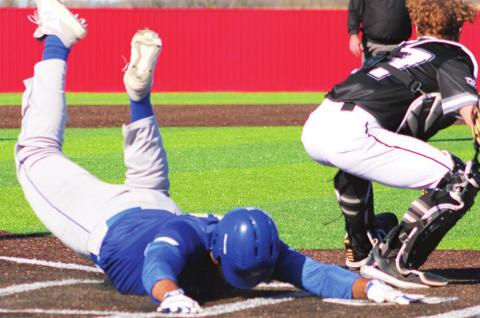 Jaylen McGuire slides safely home for the game winning run, giving the Riverton Rams the seventh inning, come-from-behind win, 5-4, over Wyandotte, Okla., Saturday in Seneca, Mo.