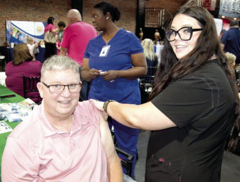 Columbus Mayor Grant Spieth received his annual flu shot at the Community Health Center of SEK during the Chamber of Commerce Expo Thursday.
