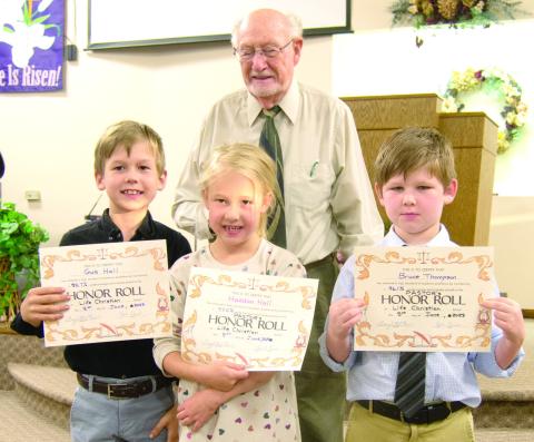 Pastor Jim Lewis recognized Pastor’s Honor Roll students Gus Hall, Haddon Hall and Bruce Thompson at a recent awards ceremony at Life Christian School.