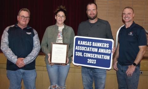 The Banker’s Award was presented to Nick and Emily Smith by Carl Mussa, (left) Soil and Water Conservation Chairman an Jim Gaither, County Key Banker, (right).