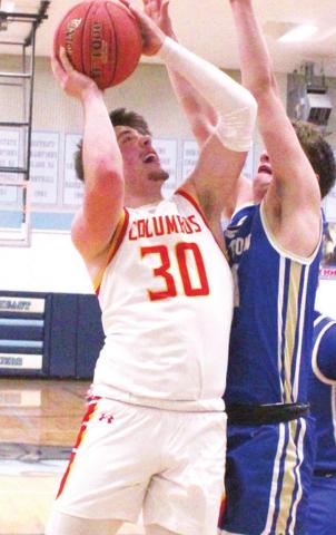 Brett Hamilton, Titan Junior, goes up for two of his team-high, 19 points, against Riverton defender, sophomore, Loch North. Brett hit a three pointer with 30 seconds to play in regulation to send the game into overtime and the eventual Columbus win, 62-59.