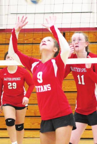 Lady Titan Ellie Helms sets the ball for her team mate in the September, eighth grade tournament at CUHS. Emerson Skye and Devyn Hopkins, Baxter Springs await the return.