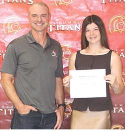 Senior Katelyn Draeger received the $1,000 American Bank Scholarship from Bank Executive, Jim Gaither, during the Columbus Unified High School Senior Assembly, May 15, at the gymnasium.