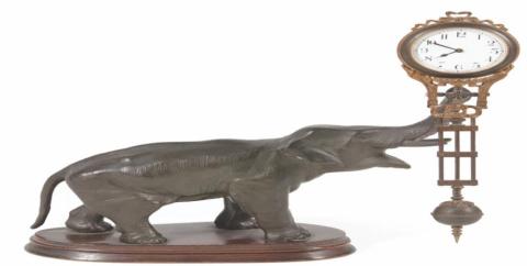 This elephant is swinging the clock, but there doesn’t seem to be anything making it move. That is why it is known as a swinger or mystery clock. It is 11 inches tall.