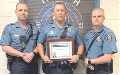 Ian Ingram presented the Life Saving certificate to Master Highway Patrol Trooper Dakota Smith as Captain Mark Drennan looks on. Courtesy photo.