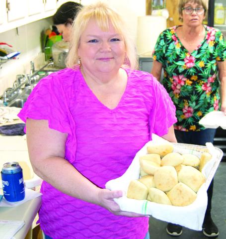 (Above) The West Mineral Eagles Lodge held a fund raising event for Ronald McDonald House. On the menu was chicken fried steak, potatoes and hot rolls. Delivering a basket of hot rolls from the kitchen was Janell Heath. At right Dayton Sims carried in bags of aluminum pop tabs from cans. Ronald McDonald House accepts the cans and tabs as a fund raiser for their good works.