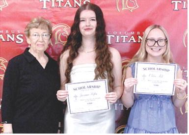 Jacianna Heflin and Chloe Ash, Columbus Unified High School Seniors, received $300 scholarships from the Mercy Columbus Auxiliary from Auxiliary Representative, Lucille McNemar, during the 2026 Senior Assembly, May 15, at the CUHS Gymnasium.