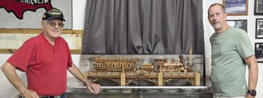 The Heart of the Heartlands Museum President Larry Spahn received the donation of a 1/24 scale wooden steam locomotive and coach car from Brian Troglia. Troglia said the train took him approximately 500 hours over four months to build. He used Cedar, Walnut, and Oak, all harvested and milled locally, to build it. Courtesy photo.