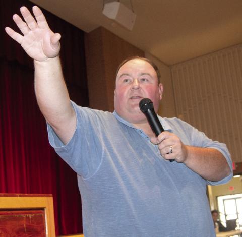 Auctioneer David Holmes watched the crowd for bidders during the County Delinquent Tax Auction held in the Columbus High School auditorium Monday afternoon. Over 100 bidders returned 87 properties to the tax rolls.
