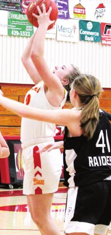 Lady Titan Freshman, Macey Allison, gets a rebound in the junior varsity game against Frontenac, Friday at the CUHS Gym. Lady Raider Freshman, Kayle Hensley awaits the outcome.