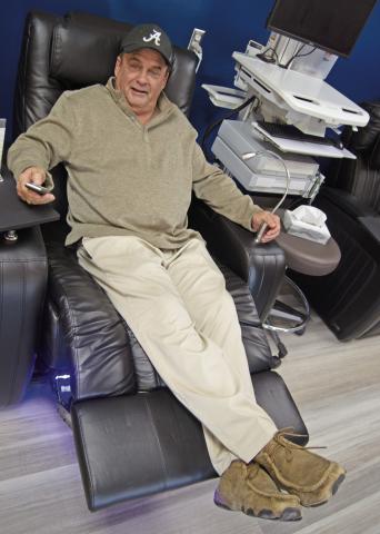Steve Dunlap tests the comfort of the new Infusion Center reclining chairs. Patients may also choose heat or vibration while receiving infusion treatments.