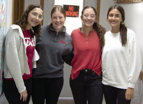 Torey Tedlock, Taryn Billings, Katy Mooney and Bryleigh Johnson were kept busy during the baked potato fundraiser put on by the Columbus PEO. Proceeds will be used to fund scholarships for young women to attend college.