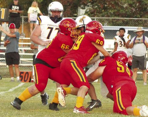 Titan Juniors, Huck Hallam and JW Tate, and sophomore, Maddox Ochsner take down the Coffeyville runner in the backfield, short of the scrimmage line in the junior varsity match up, Monday, at Titan Stadium. The Golden Tornados took the win, 28-0.