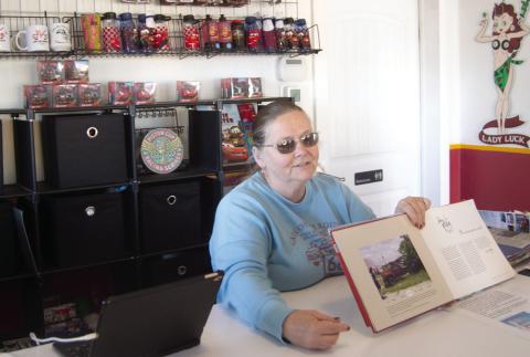 Renee Charles talks with visitors to the former gasoline station which has become a restaurant. Visitors can get a complete history of the 13.1 stretch of Route 66 through Kansas.