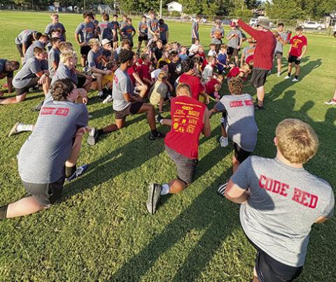 Titan Head Coach Blake Burns addresses the Titan and Mini Titan players that attended the third through sixth grade camp, August 13. Coach Burns, the Titan Coaching Staff and players will host their annual Lawn Chair Scrimmage, tomorrow, at the Central School practice field. The Mini Titans will practice beginning at 8 a.m. and the varsity and junior varsity squads will take the field at 9 a.m.