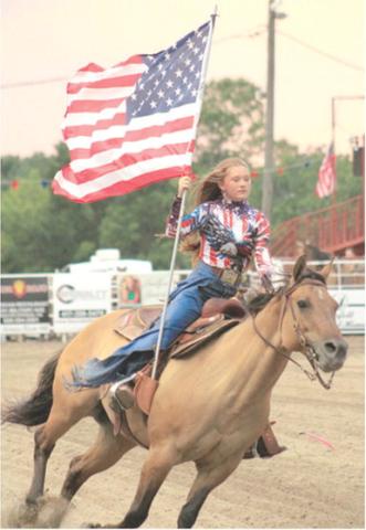 Akissa French carried the American Flag into the arena during the Baxter Springs Saddle Club rodeo held recently. Courtesy photo.