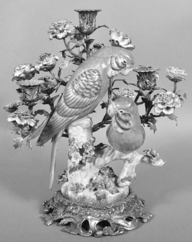With its ornate brass and painted porcelain features, this candelabrum’s primary purpose is decoration, not illumination. By the time it was made, improved forms of lighting like oil lamps and electric lights were available.