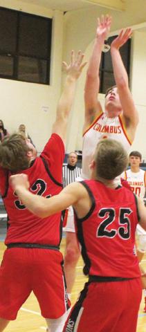 Senior, Traceton Redlon, scored two points for the Columbus Titans in their 52-41, win over the outstretched arm of Baxter Springs, sophomore, Logan Gess, Tuesday in Cherokee. Lion Freshman, Payton Gaines moves in for a possible rebound in the first round of play in the Southeast Lancer Classic Basketball Tournament.