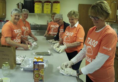 Mary Brumback, Debra Messer, Clara White, Beverly Rahmeier, Jane Ann Turner and Marilyn Epler wrapped tortillas for the Cinco de Mayo fundraiser held by Columbus Mercy Auxiliary. Chicken soft tacos with all the toppings were on the menu.