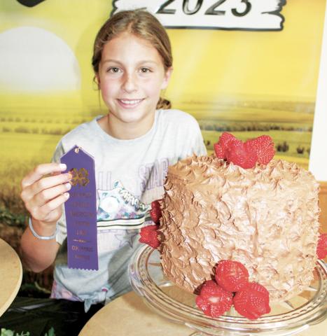 A multiple layer chocolate cake decorated with fresh strawberries earned a purple ribbon for Kinsley Hess at the foods judging. The foods competition was held July 17 in the 4-H Building.
