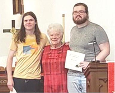 Atticus Johnson, Nancy Evans and Eliott Johnson were in attendance at the First United Methodist Church June 8 Evans presented each of the Johnsons with $1,000 scholarships. Courtesy photo.