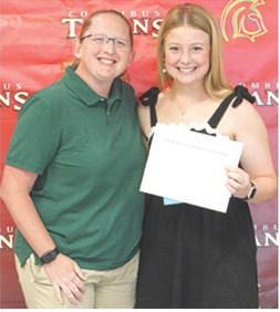 CUHS Assistant Music Director, Christine Lovell, presented the Blanche Combs Scholarship for $100 to Trinity Green at the May 15 Senior Assembly in the Columbus Unified High School Gymnasium.