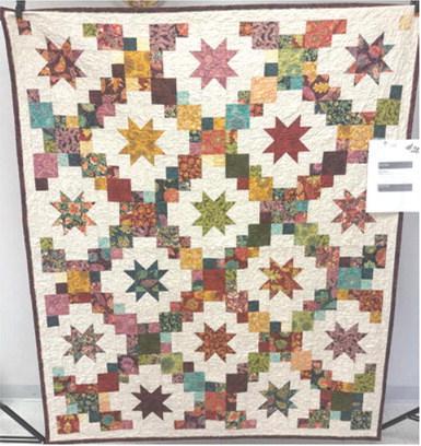 First place in the Columbus Day quilt show went to Becky Shearburn for her entry called “Brightly”.