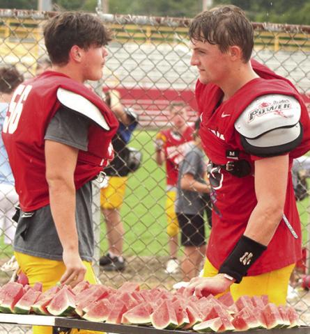 Titan Seniors, Rydge Delmont and Landin Midgett, above, and sophomore, Wyatt Yost, below, make their selections at the watermelon table following the Titan Football Annual Lawn Chair Scrimmage, Saturday morning at Titan Stadium.