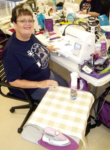 Kay Walker, Parsons, has her quilting area set up for two days of uninterrupted quilting, except for brief visiting breaks, meals and snacks. The quilters are sort of in a group of their own as the others are also.