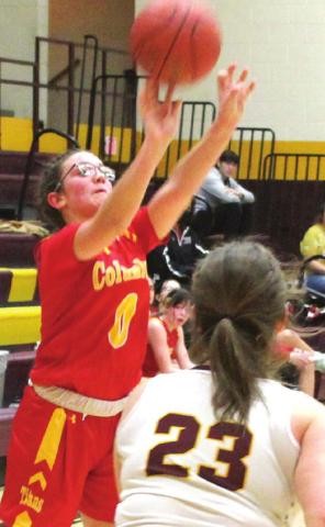 Lady Titan Freshman, Katy Mooney, shoots one of her six, treys to lead Columbus with 21 points in their 52-58, loss to the Lady Trojans in Girard, Tuesday. Senior, Faith Poland defends for Girard.