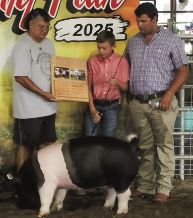 Anne Sharp presented Jaxon Harper with the Buck’s Top Showman Overall award for his swine at the Cherokee County Fair. Photo by Jadeyn Ivey.