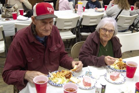 Attending the benefit for Jon Tavernaro as he struggles with Cancer were Marvin Eaton and Mary Parton. The spaghetti dinner drew a large crowd and visitors showed interest in the silent auction items.