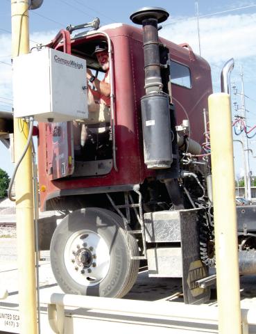 After unloading grain Craig Stover stops at the scale and place his order to take back to the fields and the other workers.