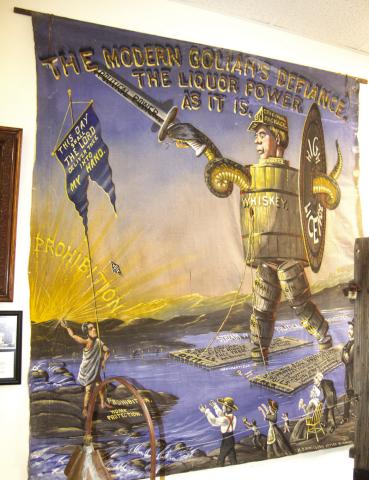 This temperance tapestry was used by Martin VanBuren Bennett, Columbus, was used as a stage prop when he spoke against the selling of drinkable alcohol in Kansas. Bennett lived on East Maple and the house still remains