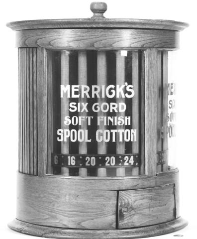 Miniature chest holding spools of thread sat on counter in country store