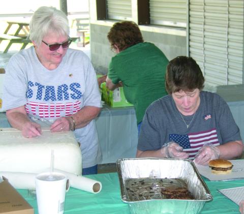 Linda Garrison and Linda Griffitt were wrapping burgers for the recent veterans and first responder appreciation lunch.