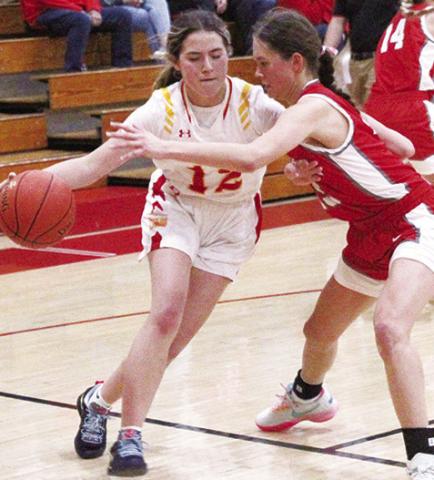 Lady Titan Junior, Ava Harman, drives around her Liberal, Mo. opponent on the way to two points in the 54-50 Columbus win, Thursday, at the Titan Gym.