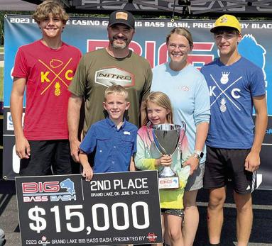 Fierce competition and a last minute weigh-in brought a second place finish for Gunnar Wixon of Baxter Springs at the Big Bass Bash in Grove, Okla. Wixon had been in the lead with his 6.53 pound catch up until the last few minutes when Joe Waggoner of Carl Junction, Mo., weighed in his 6.65 pound bass. Wixon’s family joined him for the presentation. Courtesy photo.