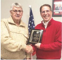 Dr. Mark Watkins, the President of Labette Community College (LCC), presented an appreciation plaque to Mike Howerter for his years of service and leadership to LCC and the Board of Trustees. Howerter served as a LCC Board of Trustees member from 2015 to 2024. Courtesy photo.