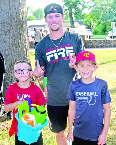 In Saturday’s Freedom Fest, sponsored by the Columbus Fire Department, Dayton Hughes and Jackson Harper won the boys six-11 years old sack race competition. Firefighter Austin Hoiser presented the prizes.