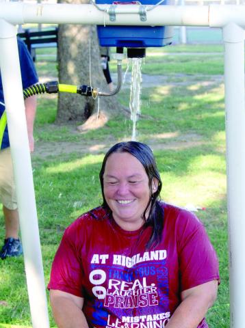 Highland Elementary teacher Bekah Noel spent time in the modern-day dunking booth. When the student hit the target the water streamed out of the bucket above her head.