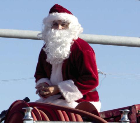 Santa once again was atop the Baxter Springs fire truck to close the Baxter Springs Christmas parade. The near perfect weather led to a large crowd and much candy for the youngsters.