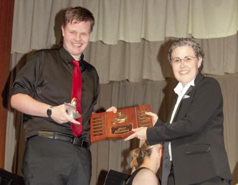Carson Cobb received the Louis Armstrong Jazz award from Columbus High School band director Gae Phillips at the spring concert.