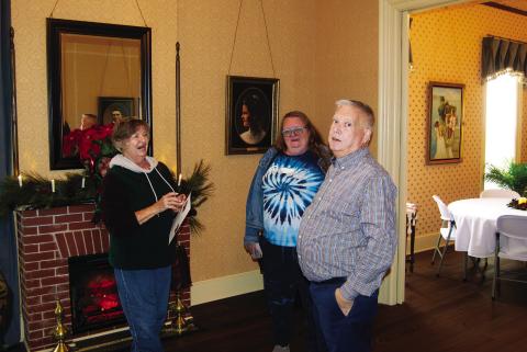 Geoffrey “Casey” Roberts acts as a tour guide for the visitors at the Rial A. Niles House open house Saturday afternoon. The fund raiser for the Baxter Springs P.E.O. Scholarship fund. The 1870 showplace has been completely remodeled back to it’s original style.