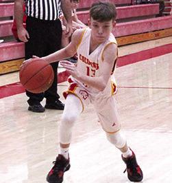 Titan Eighth Grader, Carter Woodcock, drives to the basket in games with Baxter Springs, in January, at the Central School Gymnasium.