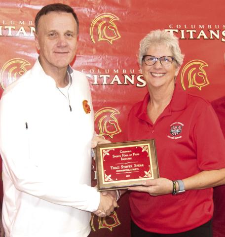 Presenting the plaque to inductee Traci Stover Spear, was Columbus Hall of Fame chairman Kerry Sachetta.