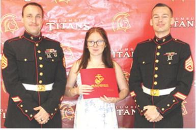 Athena Verren received recognition as a United States Marine Corps enlistee from Staff Sargent Brock, USMC and Staff Sargent Porter, USMC, during the Columbus Unified High School Senior Assembly, May 15, at the CUHS Gymnasium. Athena plans to be a motor transport operator.