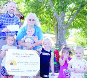Making a Difference in Childcare grants have been awarded to four Cherokee County Daycares by The Community Foundation of Southeast Kansas (CFSEK). Donna Poor with Kiddie Garden Day Care in West Mineral will be using their grant for outdoor equipment. Devin Gorman with CFSEK presented the check. Courtesy photo.