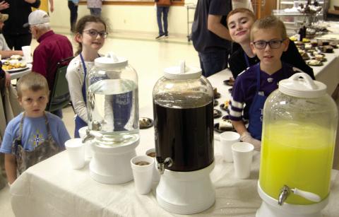 All hands are on deck when serving the annual Knights of Columbus Fish Fry in Scammon. Even the youngsters volunteer to help. Andrew Holden, Zoe Friemel, Zane Friemel and Jacob Friemel assisted at the beverage table.